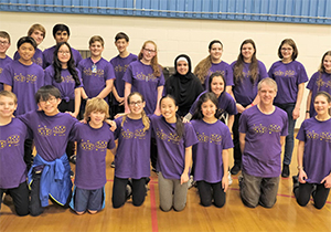 A group of students in purple shirts