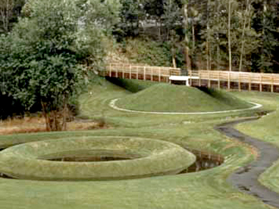 Earthworks park features circular landscaping and manmade ponds.