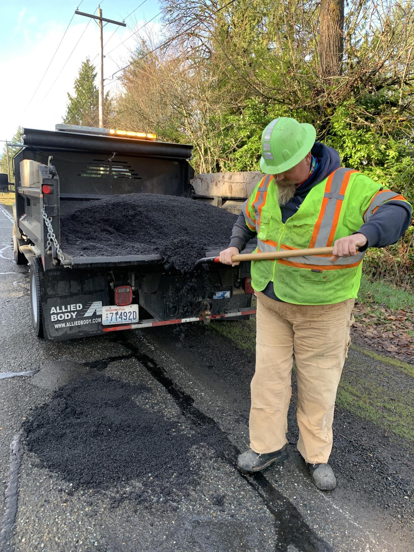 Staff filling a pothole