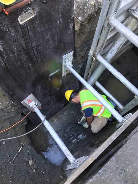 Staff member repairing drainage infrastructure