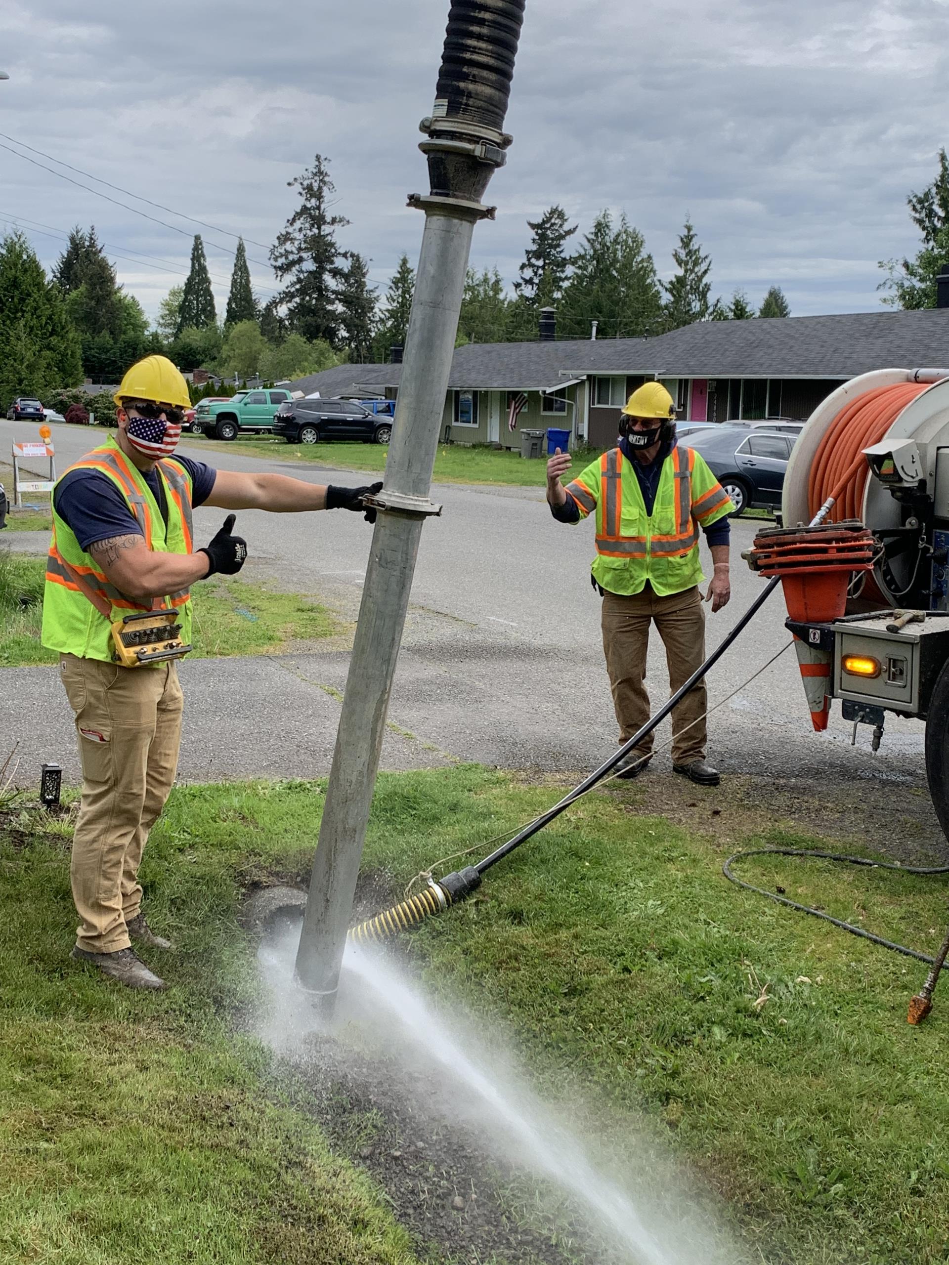 Staff completing maintenance with vactor