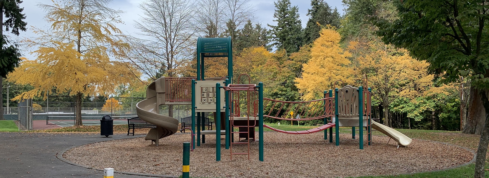 Play structure with spiral slide and climbing elements