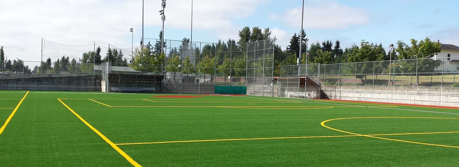 Artificial green turf field lined for youth soccer, football and baseball